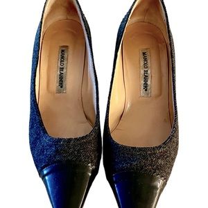 A pre-owned pair of low heels.  Outer is a gray wool with black leather.